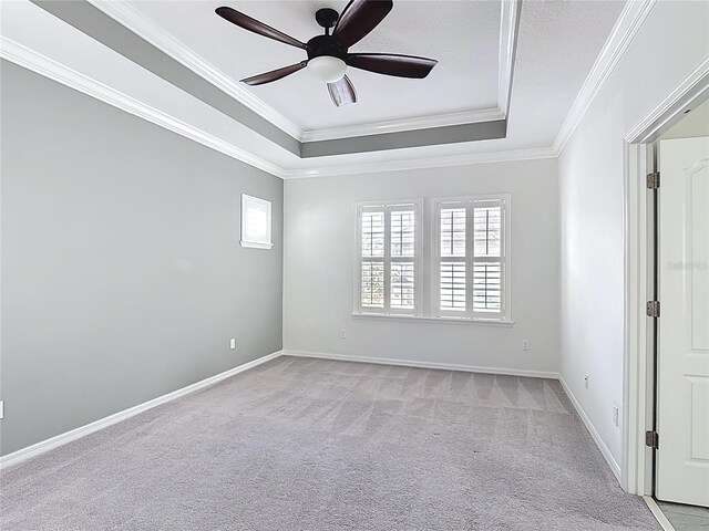 1513 Resolute St, Celebration, FL 34747 - empty room with a raised ceiling, crown molding, ceiling fan, and light colored carpet