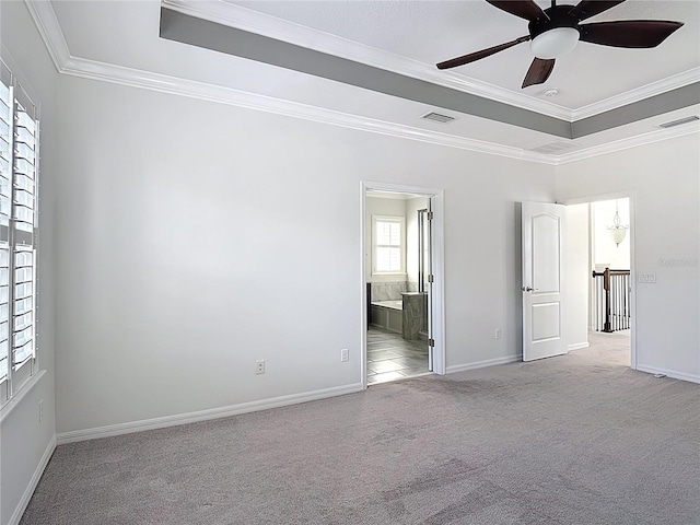 1513 Resolute St, Celebration, FL 34747 - unfurnished bedroom featuring a tray ceiling, carpet, ornamental molding, connected bathroom, and a ceiling fan