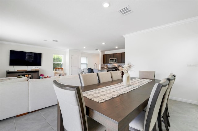 3255 Hilltop Cir, Bradenton, FL 34211 - dining space featuring crown molding, light tile patterned floors, and recessed lighting