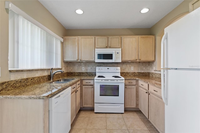 2832 Osprey Cove Pl Unit 102, Kissimmee, FL 34746 - kitchen featuring white appliances, light brown cabinetry, light stone countertops, light tile patterned floors, and decorative backsplash