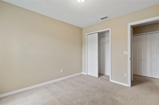 2832 Osprey Cove Pl Unit 102, Kissimmee, FL 34746 - unfurnished bedroom with carpet, a closet, and a textured ceiling