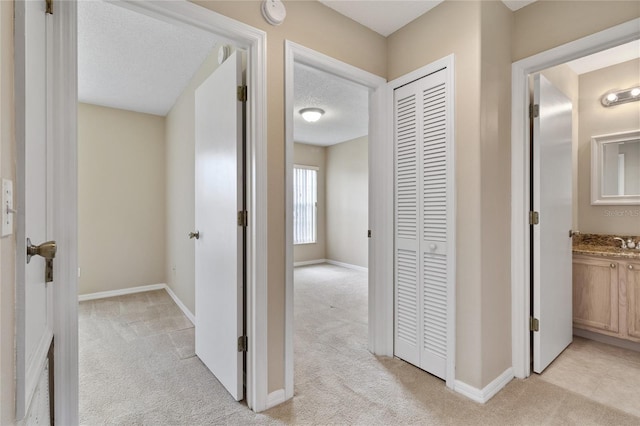 2832 Osprey Cove Pl Unit 102, Kissimmee, FL 34746 - hallway featuring light carpet and a textured ceiling