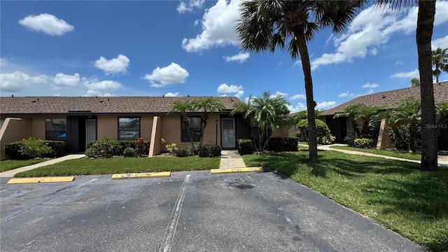 2326 St Marteen Ct, Kissimmee, FL 34741 - ranch-style home featuring uncovered parking, stucco siding, and a front lawn