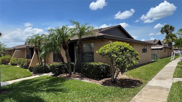 2326 St Marteen Ct, Kissimmee, FL 34741 - view of side of property featuring stucco siding and a yard