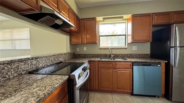 2326 St Marteen Ct, Kissimmee, FL 34741 - kitchen featuring stainless steel appliances, exhaust hood, brown cabinetry, and light tile patterned floors