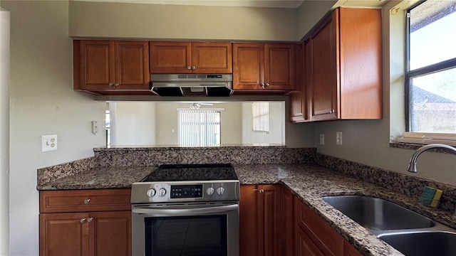 2326 St Marteen Ct, Kissimmee, FL 34741 - kitchen featuring electric range, ventilation hood, plenty of natural light, and brown cabinets