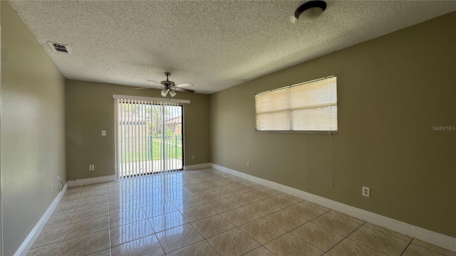 2326 St Marteen Ct, Kissimmee, FL 34741 - empty room with light tile patterned floors, ceiling fan, and a textured ceiling