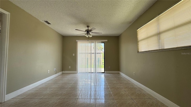 2326 St Marteen Ct, Kissimmee, FL 34741 - empty room with a ceiling fan, tile patterned floors, and a textured ceiling