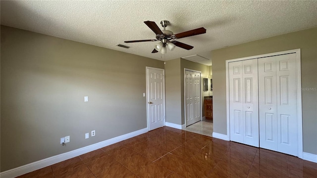 2326 St Marteen Ct, Kissimmee, FL 34741 - unfurnished bedroom featuring tile patterned flooring, a textured ceiling, and a ceiling fan