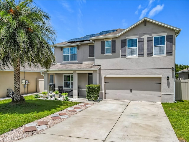 209 Willow Bend Dr, Davenport, FL 33897 - traditional-style house with stucco siding, concrete driveway, roof mounted solar panels, an attached garage, and covered porch