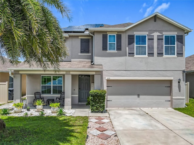 209 Willow Bend Dr, Davenport, FL 33897 - view of front facade featuring stucco siding, a porch, driveway, and roof mounted solar panels
