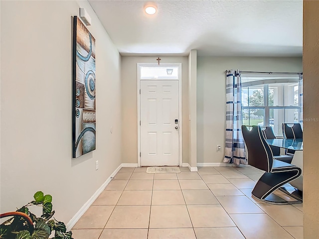 209 Willow Bend Dr, Davenport, FL 33897 - entryway with light tile patterned floors and baseboards