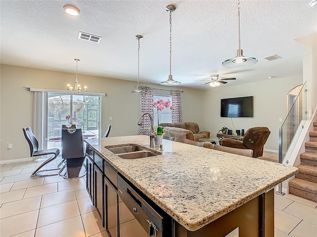 209 Willow Bend Dr, Davenport, FL 33897 - kitchen with stainless steel dishwasher, healthy amount of natural light, a textured ceiling, ceiling fan, and hanging light fixtures