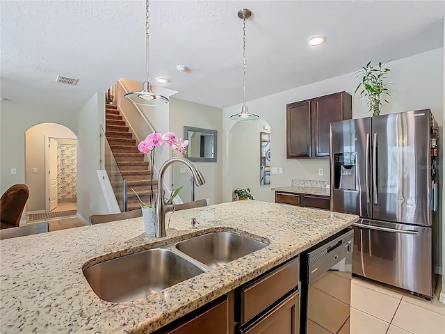 209 Willow Bend Dr, Davenport, FL 33897 - kitchen with stainless steel refrigerator with ice dispenser, arched walkways, dishwashing machine, light tile patterned floors, and recessed lighting