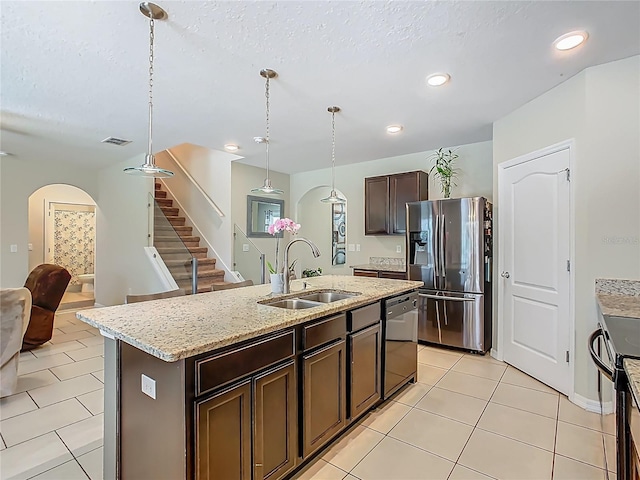 209 Willow Bend Dr, Davenport, FL 33897 - kitchen with stainless steel refrigerator with ice dispenser, black dishwasher, dark brown cabinetry, electric stove, and light tile patterned flooring