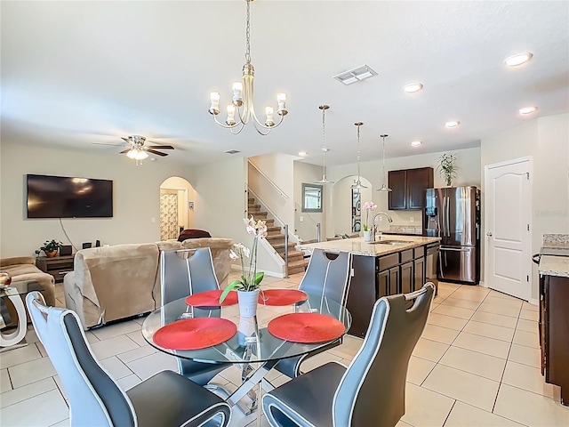 209 Willow Bend Dr, Davenport, FL 33897 - dining area with stairway, a ceiling fan, recessed lighting, arched walkways, and light tile patterned floors