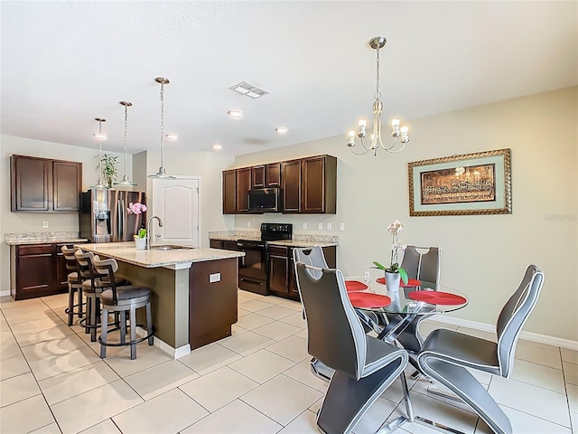 209 Willow Bend Dr, Davenport, FL 33897 - kitchen with black / electric stove, stainless steel fridge with ice dispenser, a kitchen bar, dark brown cabinetry, and a chandelier