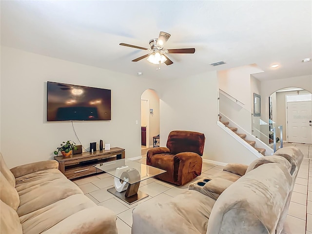 209 Willow Bend Dr, Davenport, FL 33897 - living room with arched walkways, a ceiling fan, stairway, light tile patterned flooring, and recessed lighting