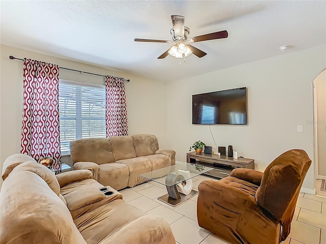 209 Willow Bend Dr, Davenport, FL 33897 - living area with light tile patterned floors, a ceiling fan, and arched walkways
