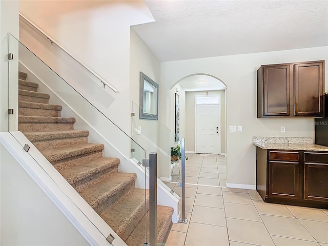 209 Willow Bend Dr, Davenport, FL 33897 - entryway with arched walkways, light tile patterned floors, and stairs