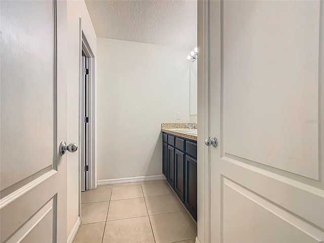 209 Willow Bend Dr, Davenport, FL 33897 - bathroom with vanity, tile patterned flooring, and a textured ceiling
