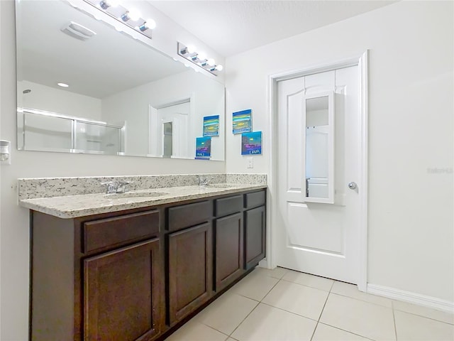 209 Willow Bend Dr, Davenport, FL 33897 - full bath featuring double vanity, tile patterned flooring, and an enclosed shower