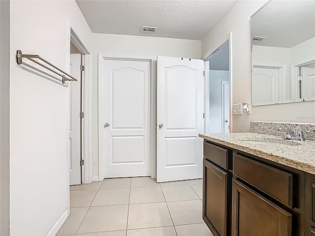 209 Willow Bend Dr, Davenport, FL 33897 - bathroom featuring vanity, tile patterned flooring, and a textured ceiling