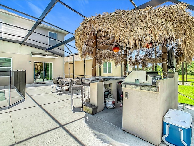 209 Willow Bend Dr, Davenport, FL 33897 - view of patio / terrace featuring exterior kitchen, glass enclosure, and outdoor dining space