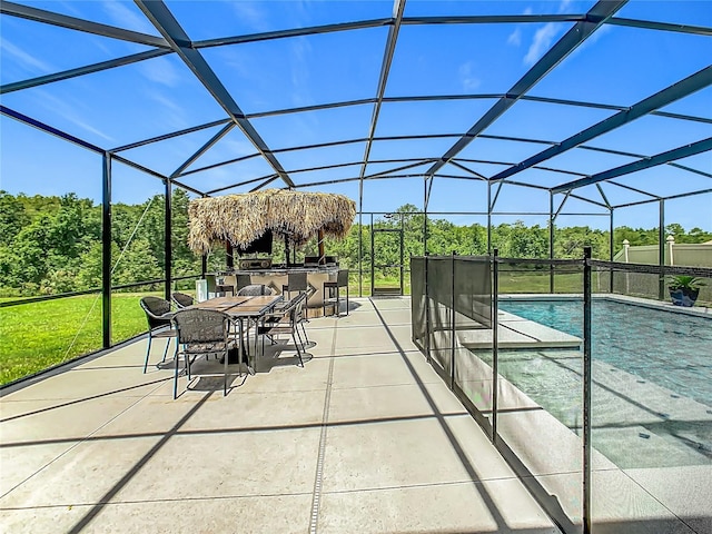 209 Willow Bend Dr, Davenport, FL 33897 - swimming pool with a patio area, glass enclosure, outdoor dining area, and exterior kitchen