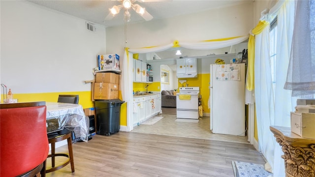 1431 Jack Calhoun Dr, Kissimmee, FL 34741 - kitchen featuring white appliances, a ceiling fan, light wood-type flooring, and white cabinetry