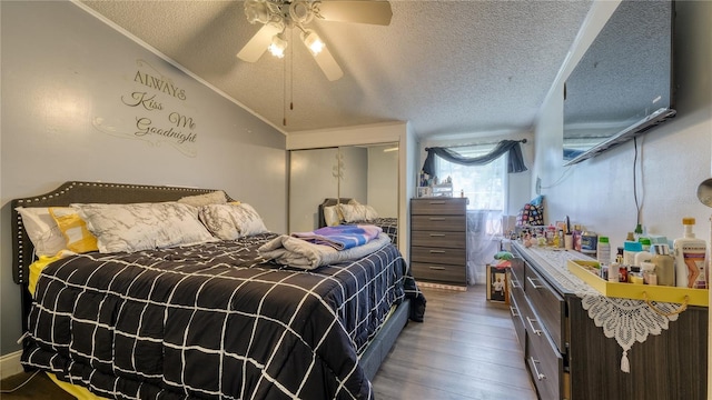 1431 Jack Calhoun Dr, Kissimmee, FL 34741 - bedroom with a textured ceiling, hardwood / wood-style flooring, vaulted ceiling, and ceiling fan