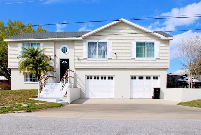 4151 Nelson Rd, Lake Wales, FL 33898 - bi-level home featuring a garage, concrete driveway, and stucco siding