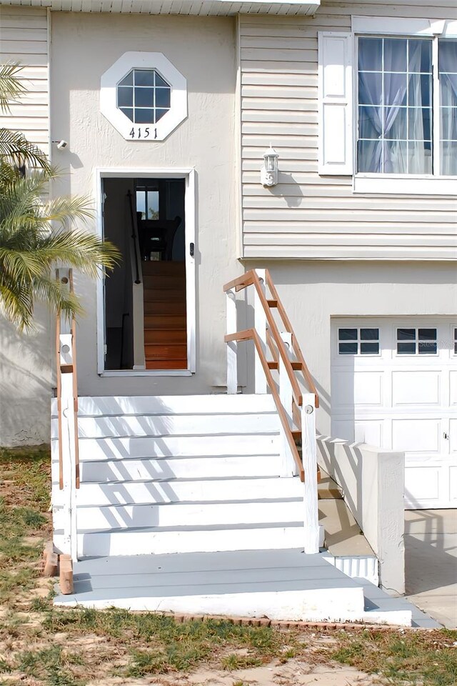 4151 Nelson Rd, Lake Wales, FL 33898 - entrance to property featuring an attached garage and stucco siding