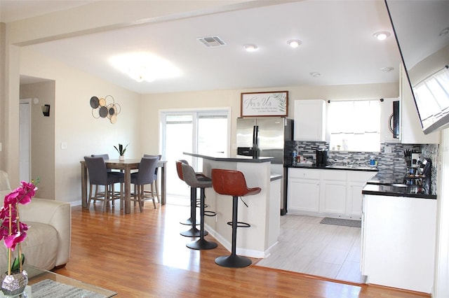 4151 Nelson Rd, Lake Wales, FL 33898 - kitchen with dark countertops, appliances with stainless steel finishes, plenty of natural light, and a kitchen breakfast bar