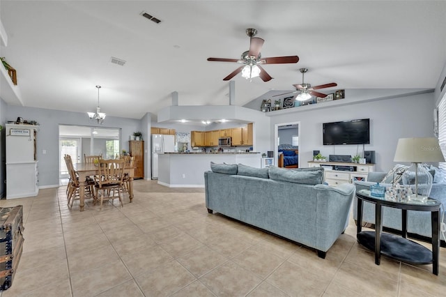 6396 Bennett Ct, Saint Cloud, FL 34771 - living room with lofted ceiling, light tile patterned floors, a ceiling fan, and a chandelier