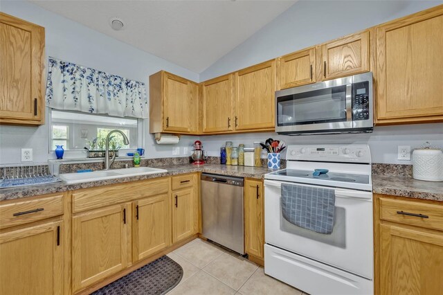6396 Bennett Ct, Saint Cloud, FL 34771 - kitchen featuring appliances with stainless steel finishes, lofted ceiling, and light tile patterned floors