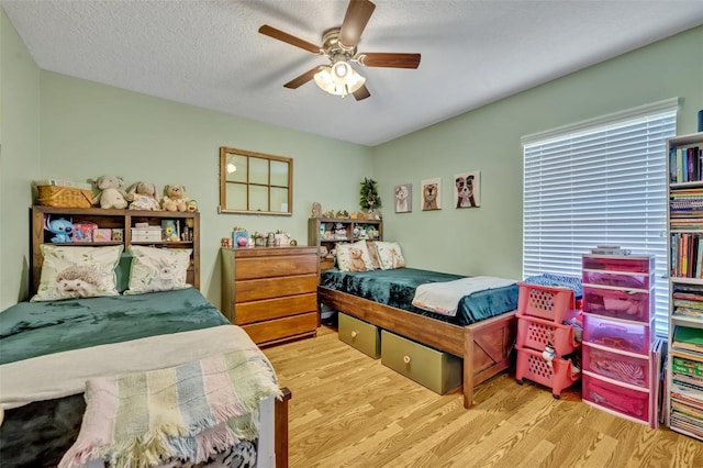 6396 Bennett Ct, Saint Cloud, FL 34771 - bedroom with wood finished floors, ceiling fan, and a textured ceiling