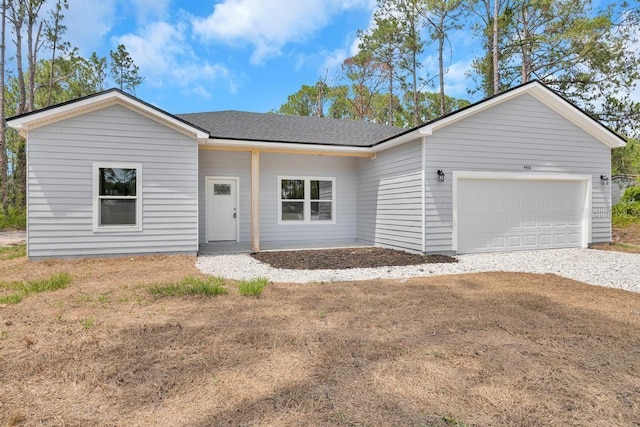 4410 Vicky St, Hastings, FL 32145 - view of front of home featuring gravel driveway, an attached garage, and roof with shingles