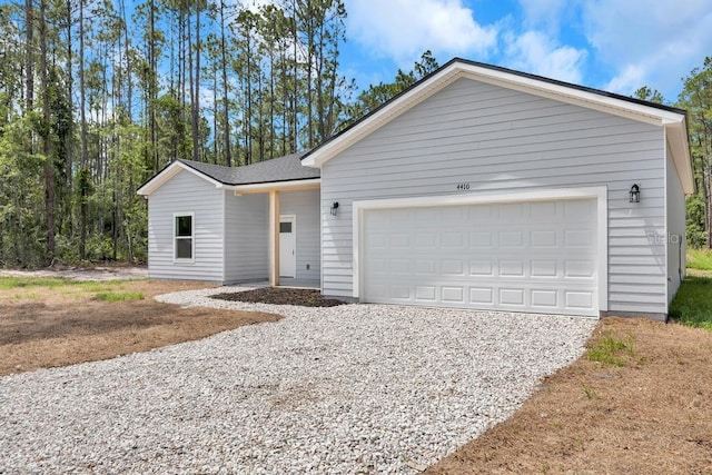 4410 Vicky St, Hastings, FL 32145 - view of front of home featuring gravel driveway and a garage