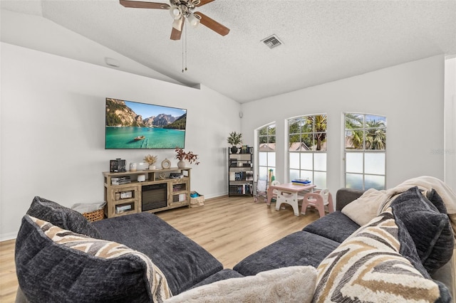 138 Hidden Pointe Ln, Groveland, FL 34736 - living room with lofted ceiling, wood finished floors, ceiling fan, and a textured ceiling