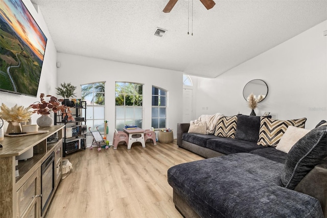 138 Hidden Pointe Ln, Groveland, FL 34736 - living area featuring light wood-style floors, a textured ceiling, and ceiling fan