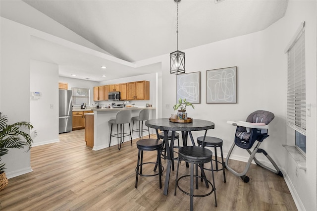 138 Hidden Pointe Ln, Groveland, FL 34736 - dining room featuring vaulted ceiling, light wood-style floors, and recessed lighting