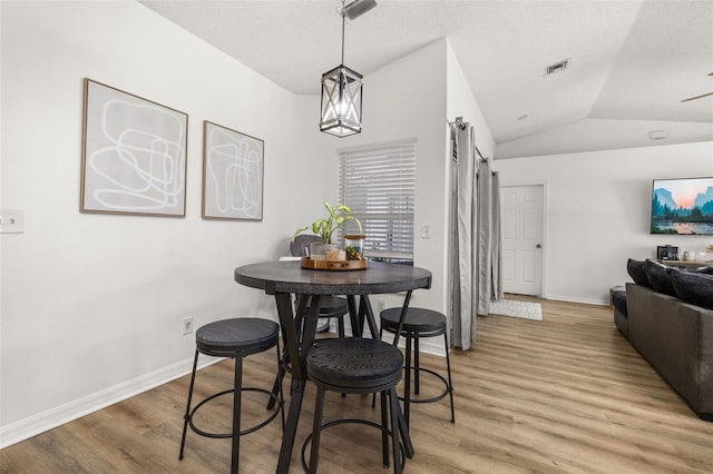 138 Hidden Pointe Ln, Groveland, FL 34736 - dining space with lofted ceiling, light wood-type flooring, and a barn door