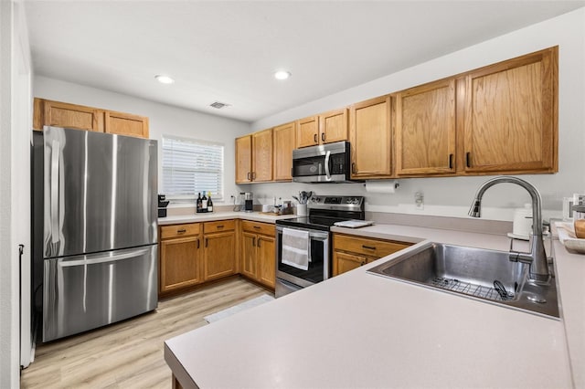 138 Hidden Pointe Ln, Groveland, FL 34736 - kitchen featuring stainless steel appliances, light wood-type flooring, recessed lighting, and light countertops