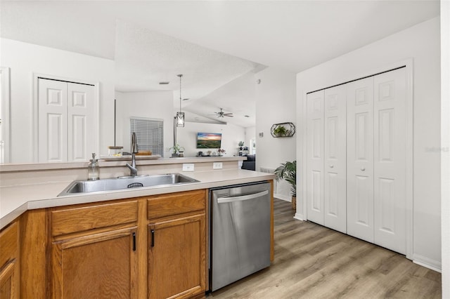 138 Hidden Pointe Ln, Groveland, FL 34736 - kitchen featuring dishwasher, lofted ceiling, brown cabinetry, light wood-style flooring, and open floor plan