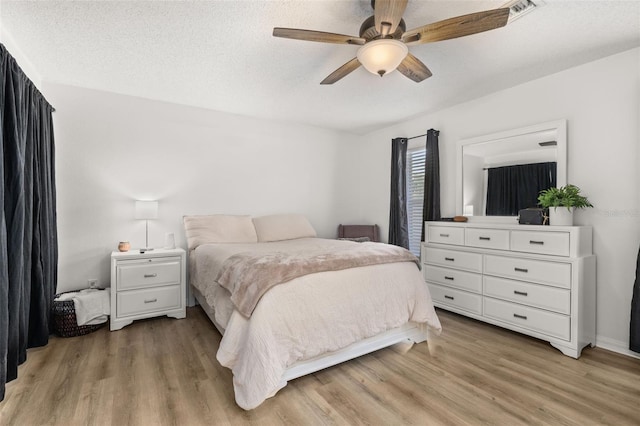 138 Hidden Pointe Ln, Groveland, FL 34736 - bedroom with light wood finished floors and a ceiling fan