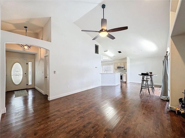 238 Sunridge Woods Blvd, Davenport, FL 33837 - unfurnished living room with a ceiling fan, arched walkways, high vaulted ceiling, and dark wood-style floors