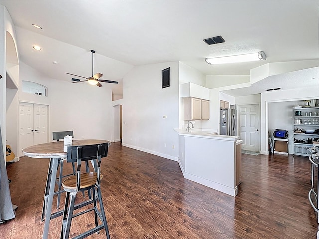 238 Sunridge Woods Blvd, Davenport, FL 33837 - kitchen featuring freestanding refrigerator, a ceiling fan, dark wood-type flooring, arched walkways, and a peninsula