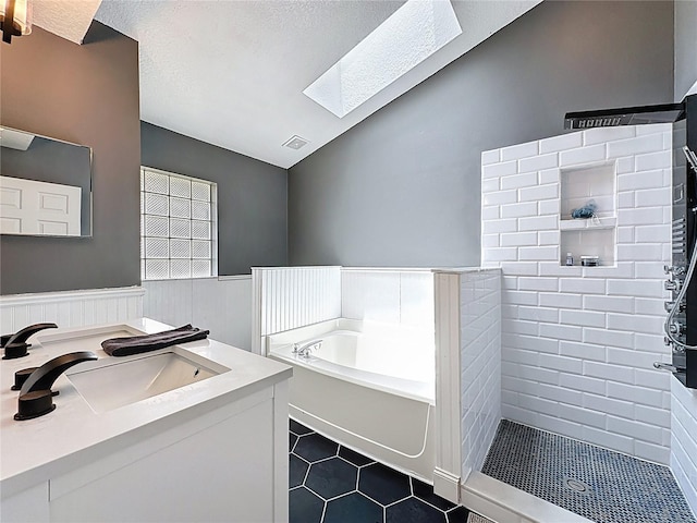 238 Sunridge Woods Blvd, Davenport, FL 33837 - bathroom featuring lofted ceiling, a skylight, a garden tub, vanity, and tiled shower
