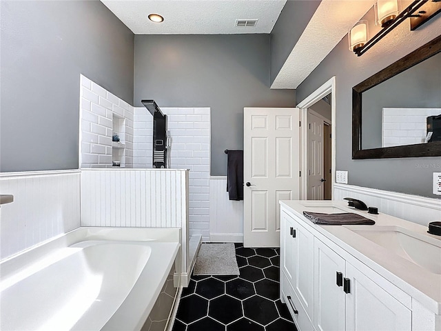 238 Sunridge Woods Blvd, Davenport, FL 33837 - bathroom with a wainscoted wall, a garden tub, double vanity, tile patterned flooring, and walk in shower